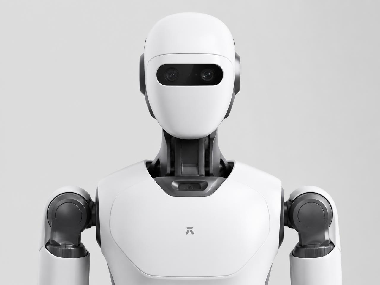 Close studio portrait of the Optimus humanoid robot head and torso